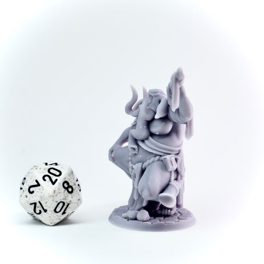 Gray elephant figurine with a die on a white background