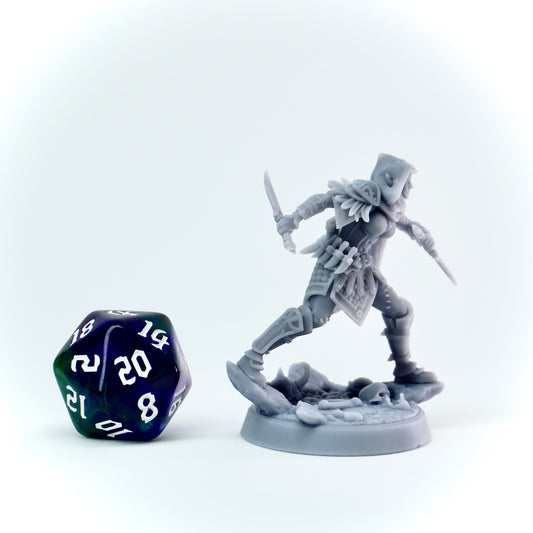 Gray fantasy rogue figurine with a polyhedral dice on a white background