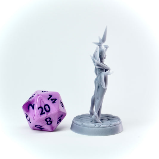Gray figurine and purple polyhedral dice on a white background