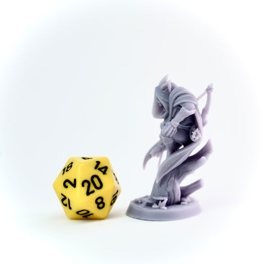 Gray figurine and yellow polyhedral dice on a white background