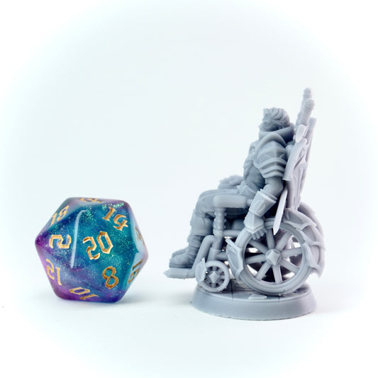 Gray wheelchair figurine with a purple and blue die on a white background