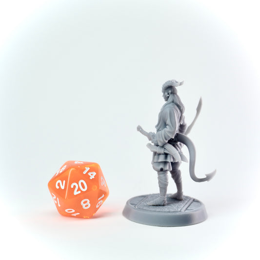 Gray miniature figurine of a warrior with a sword next to an orange polyhedral dice on a white background