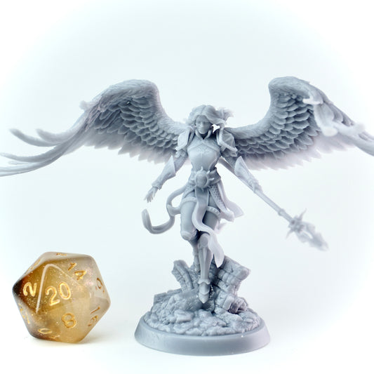 Gray angel figurine with wings and a spear next to a gold polyhedral dice on a white background