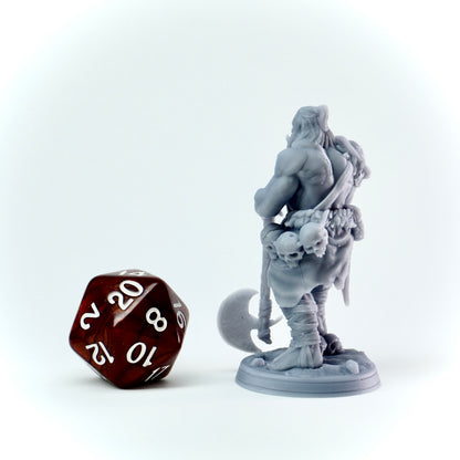Gray fantasy figurine with a brown polyhedral dice on a white background