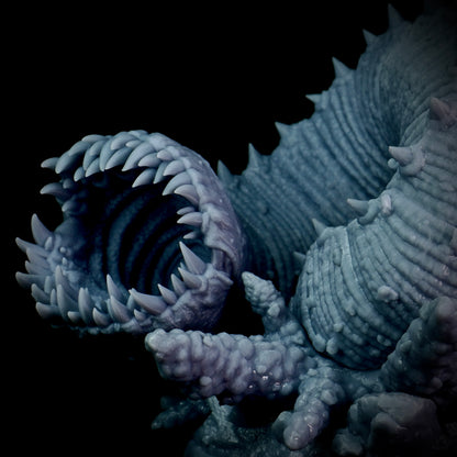Close-up of a textured, purple worm creature with a dark background