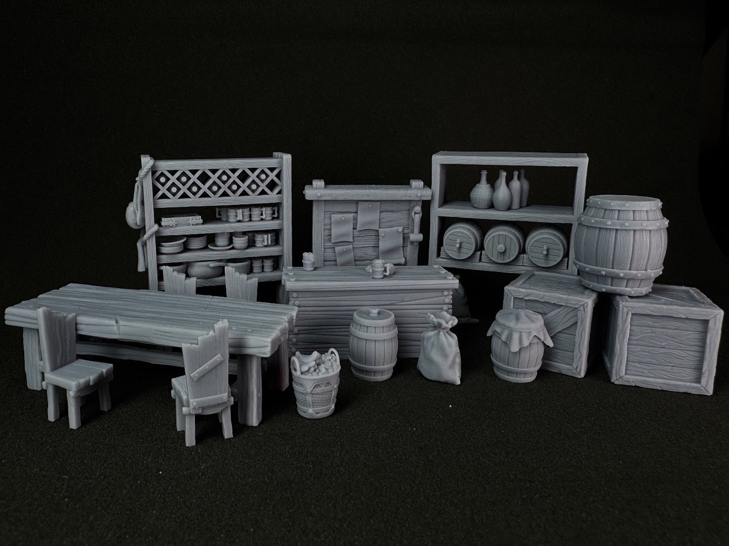 Collection of 3D-printed miniature furniture and props on a black background