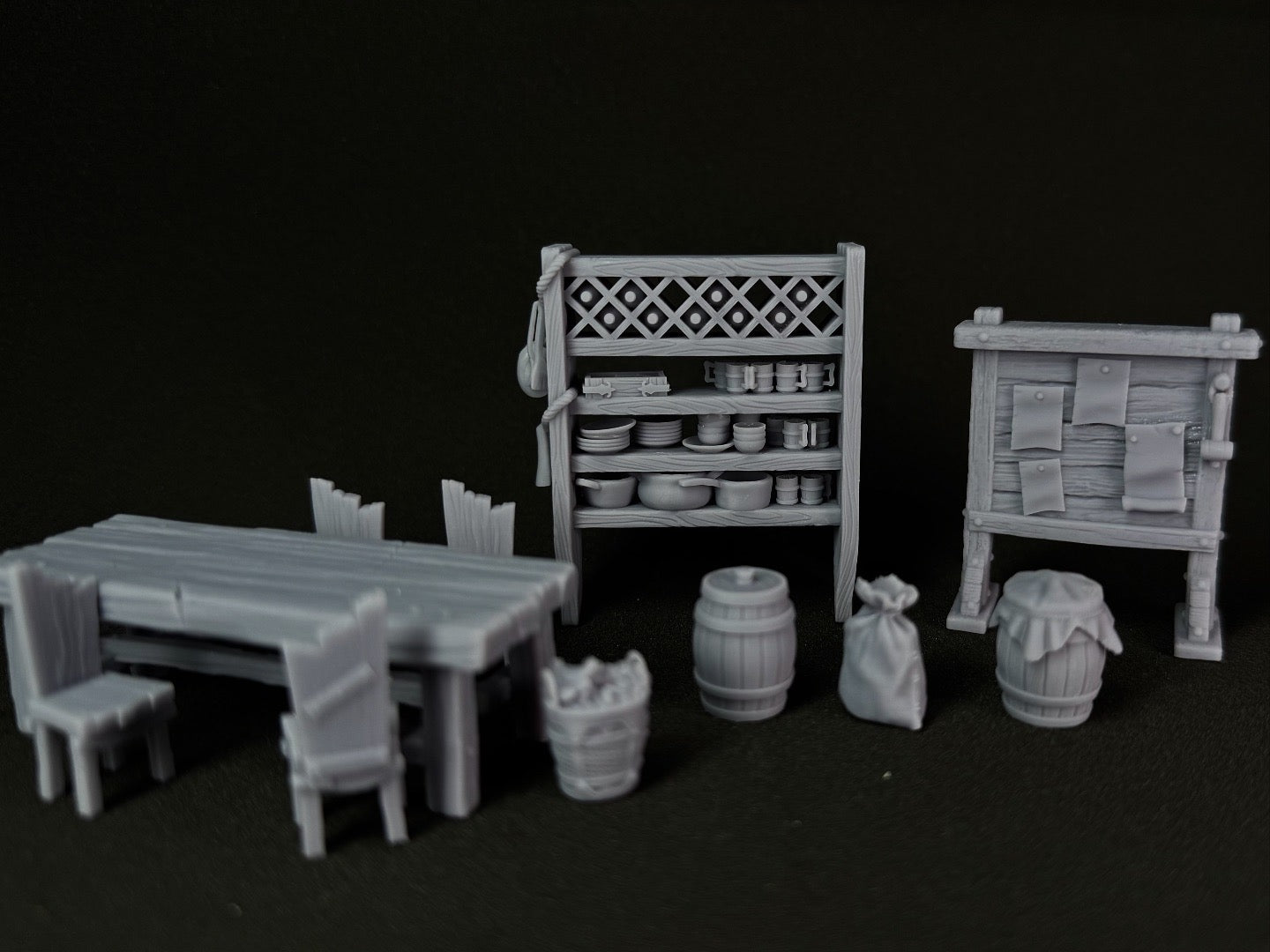 Set of miniature furniture and props on a black background