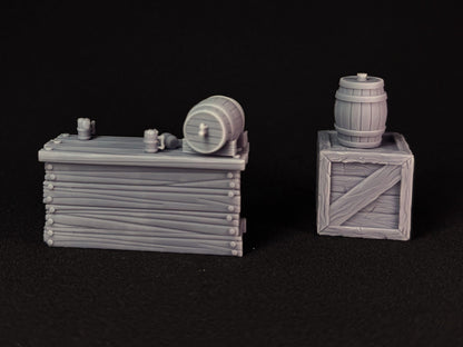 Two miniature wooden crates with barrels on top with a black background
