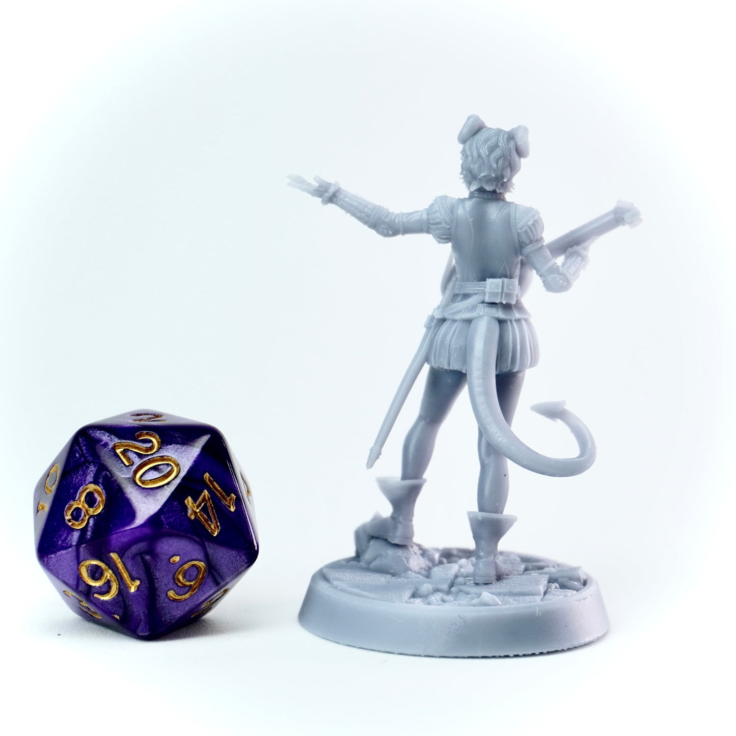 Gray figurine of a bard tiefling with a lute next to a polyhedral dice on a white background