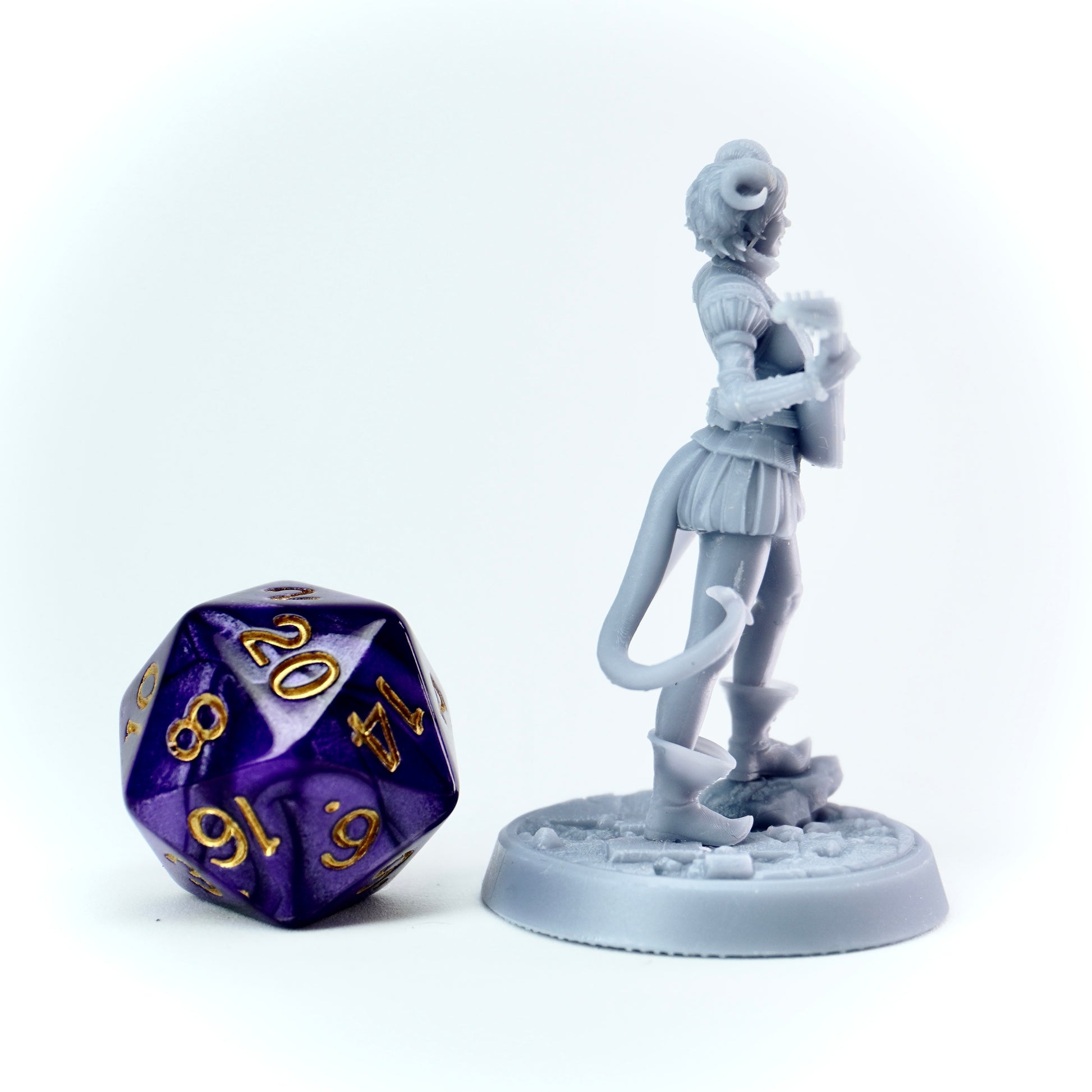 Unpainted bard tiefling miniature figure of a fantasy character with a lute, next to a 20-sided die on a white background.