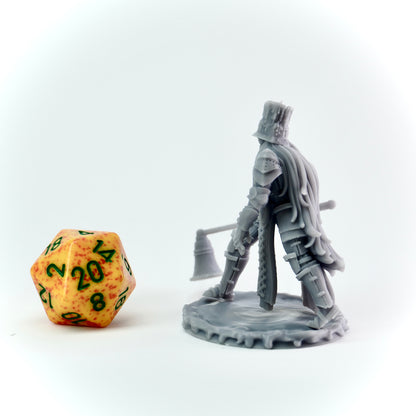 Gray miniature figure of a warrior with a large candle snuffer next to a d20 dice on a white background
