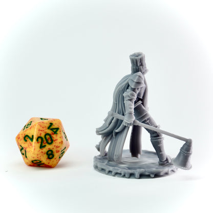 Gray miniature figure of a warrior with a large candle snuffer next to a d20 dice on a white background