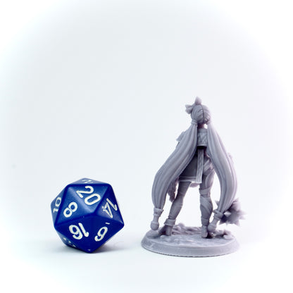 Gray fantasy figurine with long hair next to a blue polyhedral dice on a white background