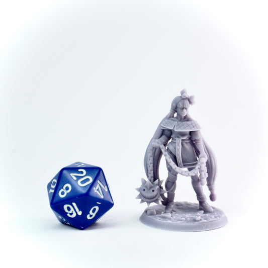 Gray fantasy figurine with a blue polyhedral dice on a white background