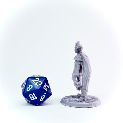 Gray miniature figure of a warrior with a blue polyhedral dice on a white background