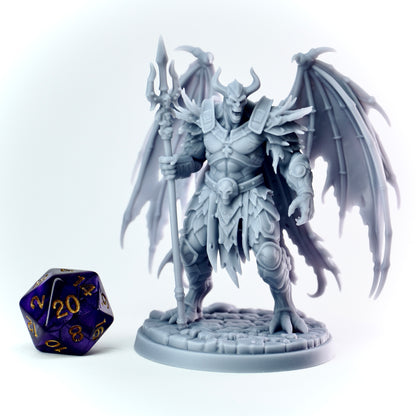 Fantasy demon figurine with wings and armor next to a polyhedral dice on a white background