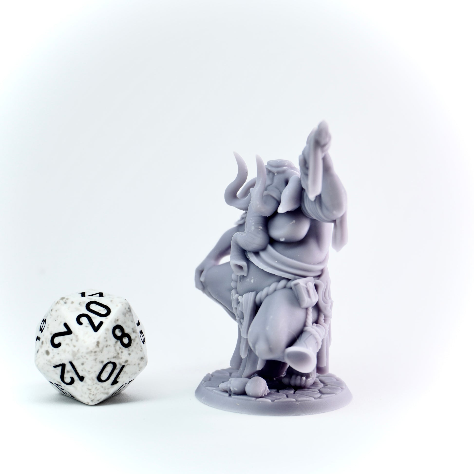 Gray elephant figurine with a die on a white background