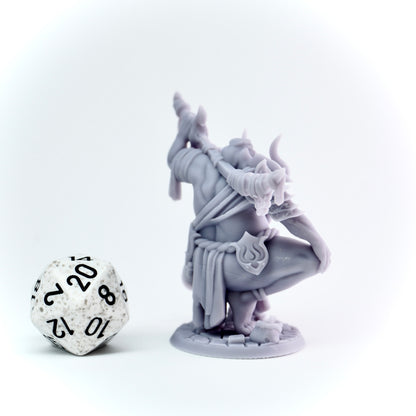 Gray fantasy figurine with a large die on a white background