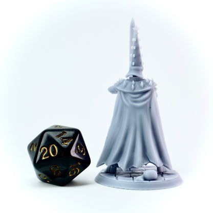 White fantasy figure with a tall tower-like helmet next to a black polyhedral dice on a white background