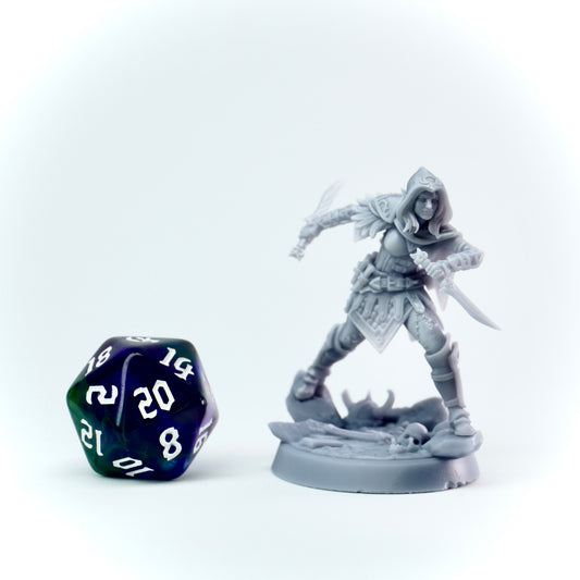 Gray miniature figure of a rogue with a polyhedral dice on a white background
