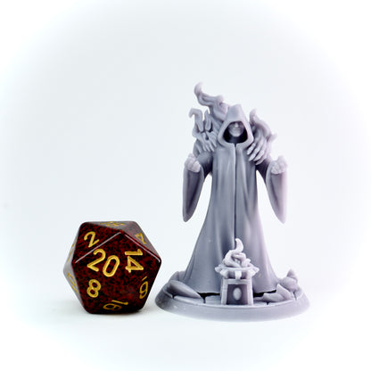 Gray fantasy figurine next to a polyhedral dice on a white background