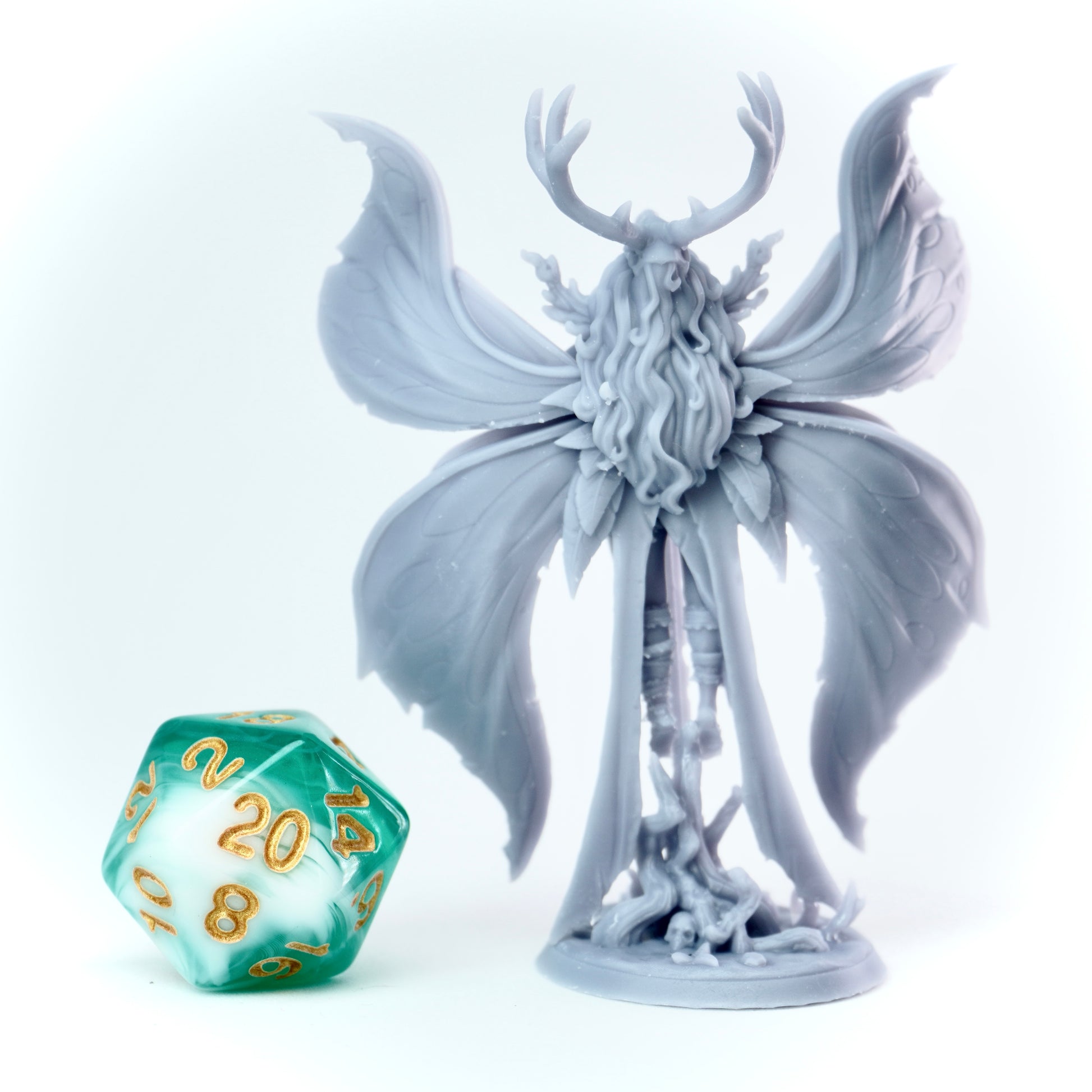 Statue of a winged fey-like creature with a large sword next to it on a white background