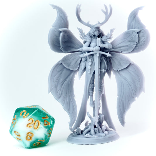 Fantasy fey figurine with butterfly wings and a large sword on a white background