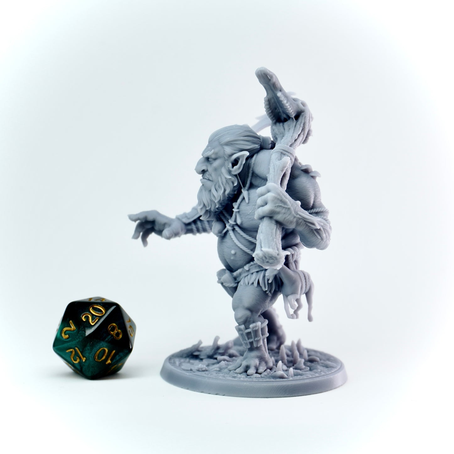 Gray fantasy troll figurine with a weapon on a white background