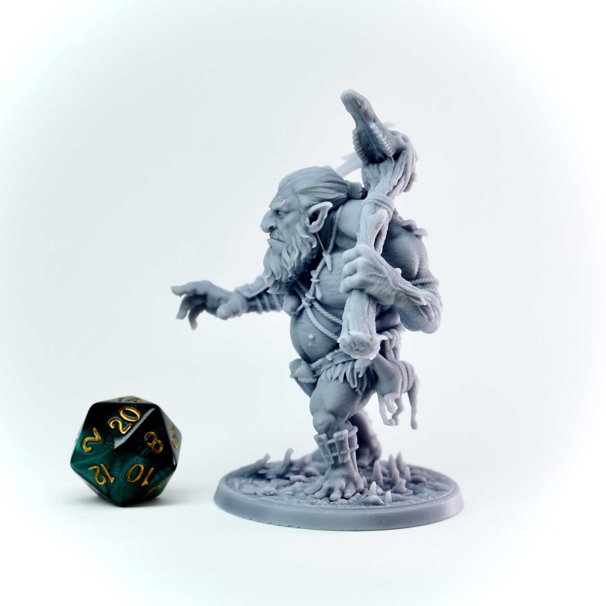 Gray fantasy troll figurine with a weapon on a white background