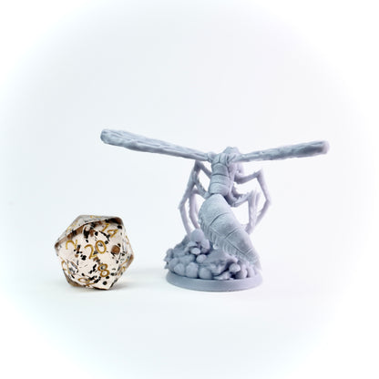 Gre fantasy figurine with a large die on a white background