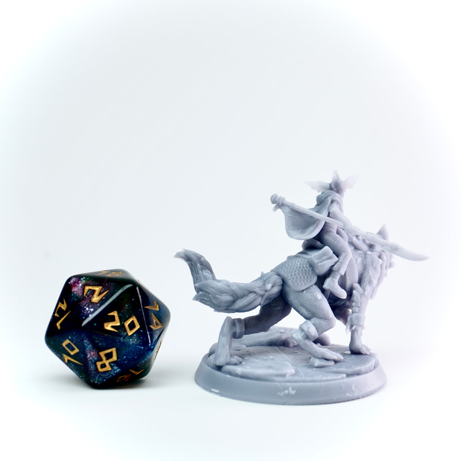 Gray fantasy figurine of a warrior on a wolf with a D20 dice on a white background