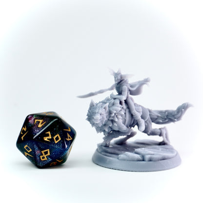Gray fantasy figurine and a large polyhedral dice on a white background