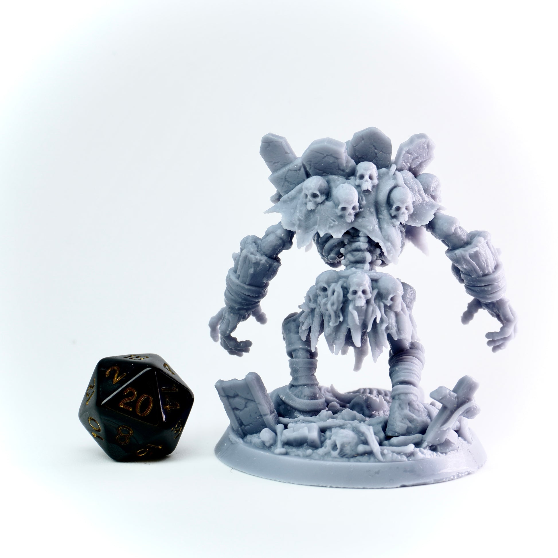 Gray miniature figure with skeletal elements on a white background