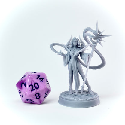 Gray fantasy figurine with a purple polyhedral dice on a white background
