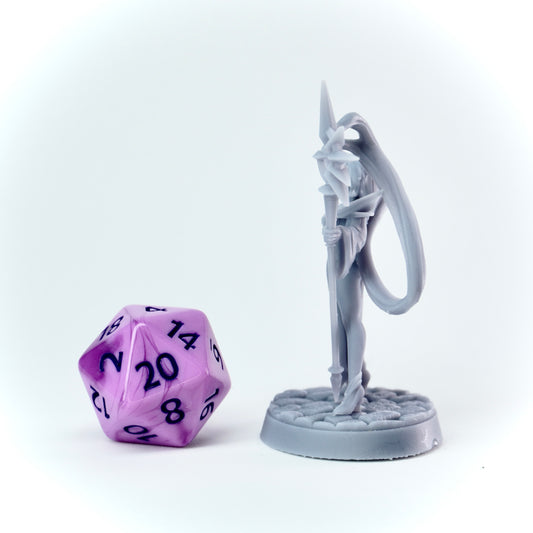Gray fantasy figurine with a purple polyhedral dice on a white background