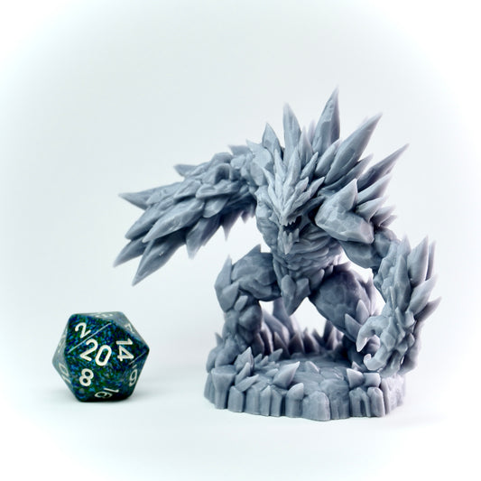 Gray ice spiked figurine with a D20 dice on a white background