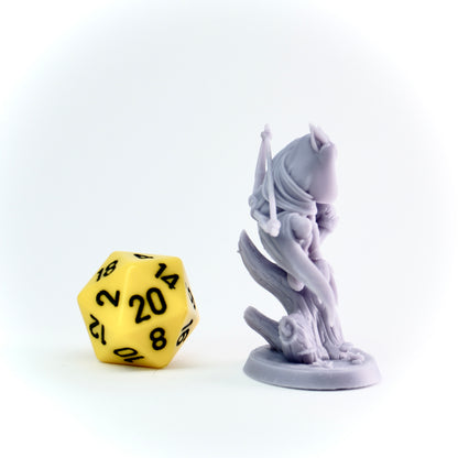 Yellow polyhedral dice next to a gray fantasy figurine on a white background