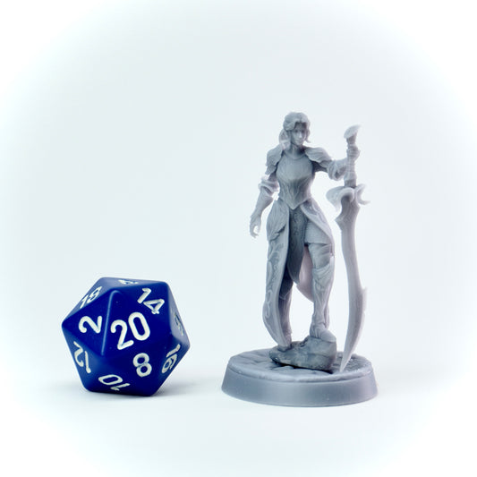 Gray fantasy figurine of a warrior with a blue and white dice on a white background