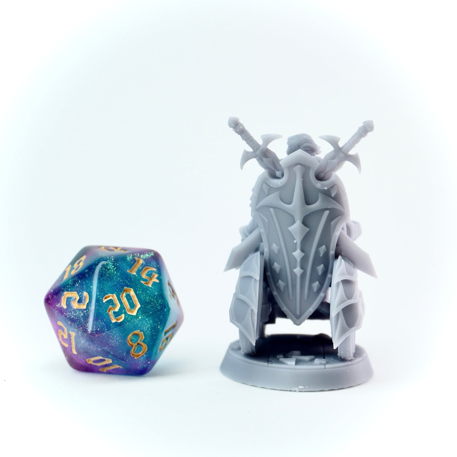 Gray fantasy figurine with a sword on a white background