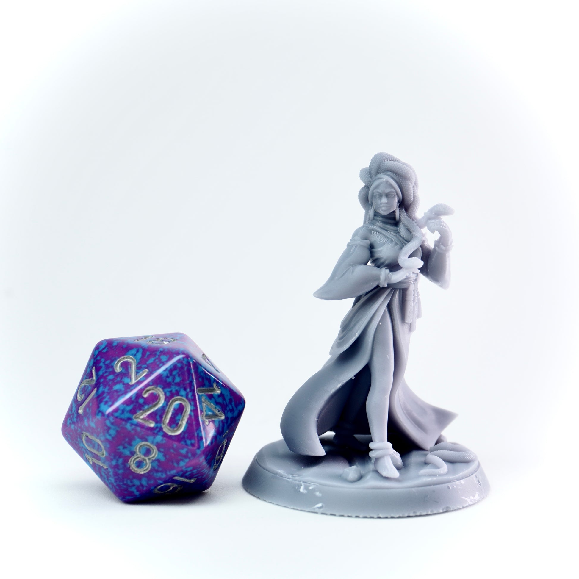 Gray figurine of a character with a purple polyhedral dice on a white background