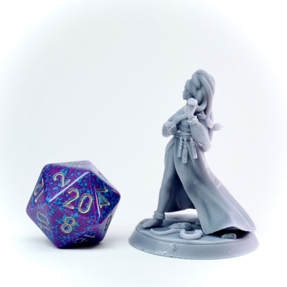 Gray fantasy figurine with a large polyhedral dice on a white background