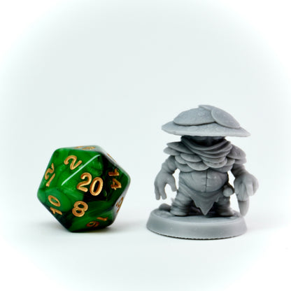 Gray miniature figure and green polyhedral dice on a white background