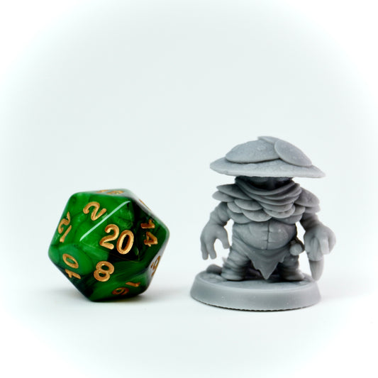 Gray miniature figure and green polyhedral dice on a white background