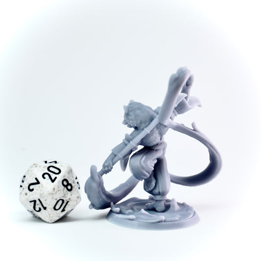 Gray fantasy figurine with a brush weapon and a die on a white background