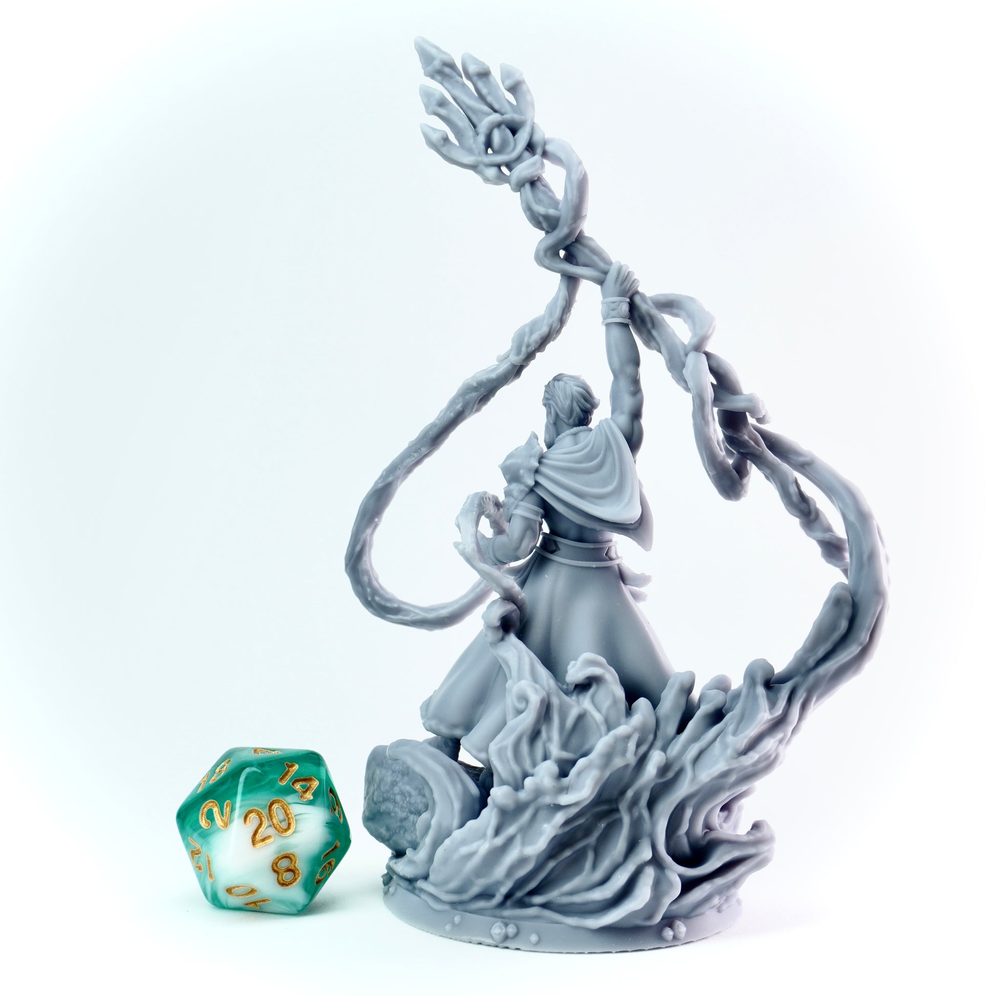 Gray figurine of a sea warrior on a white background with a green and gold die.