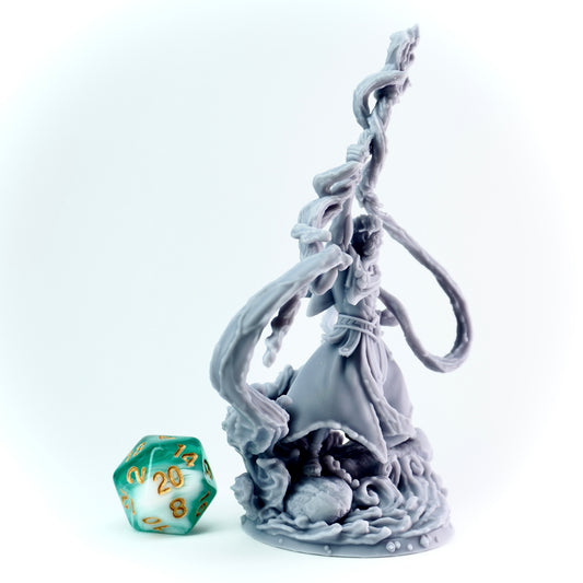 Statue like miniature of ancient god with a water spell and a green polyhedral dice on a white background