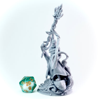 Gray figurine of a warrior with a trident, next to a green polyhedral dice on a white background