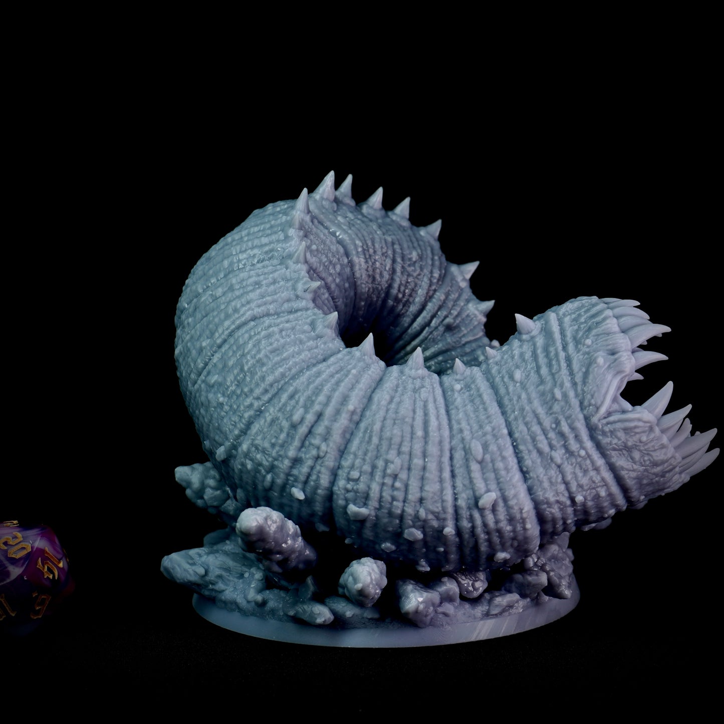 Close-up of a detailed model of a large, segmented creature with spines on a black background.