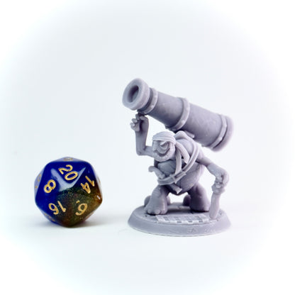 Gray miniature figure with a cannon and a D20 dice on a white background