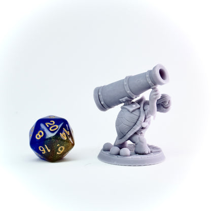 Gray figurine with a cannon and a polyhedral dice on a white background